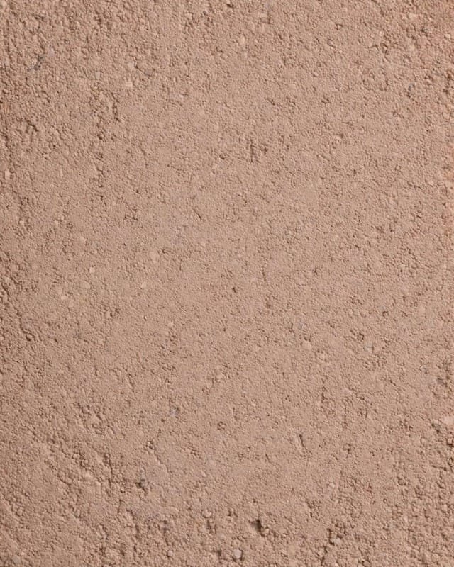 Close surface study of Clayworks Demi Rustic clay plaster showing hand-applied texture and mineral aggregate