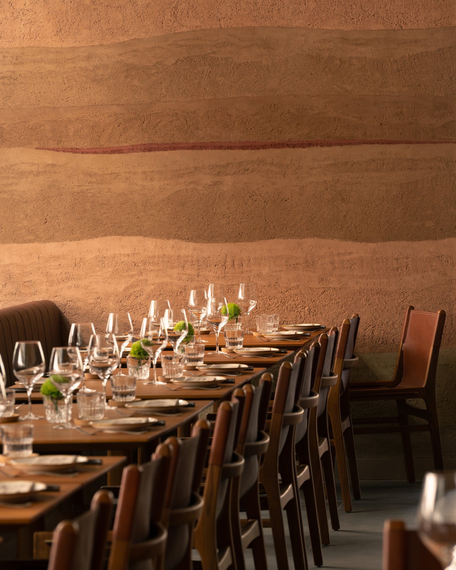Custom rammed earth plaster in Quebracho red-brown at Fireplace by Bedrock.