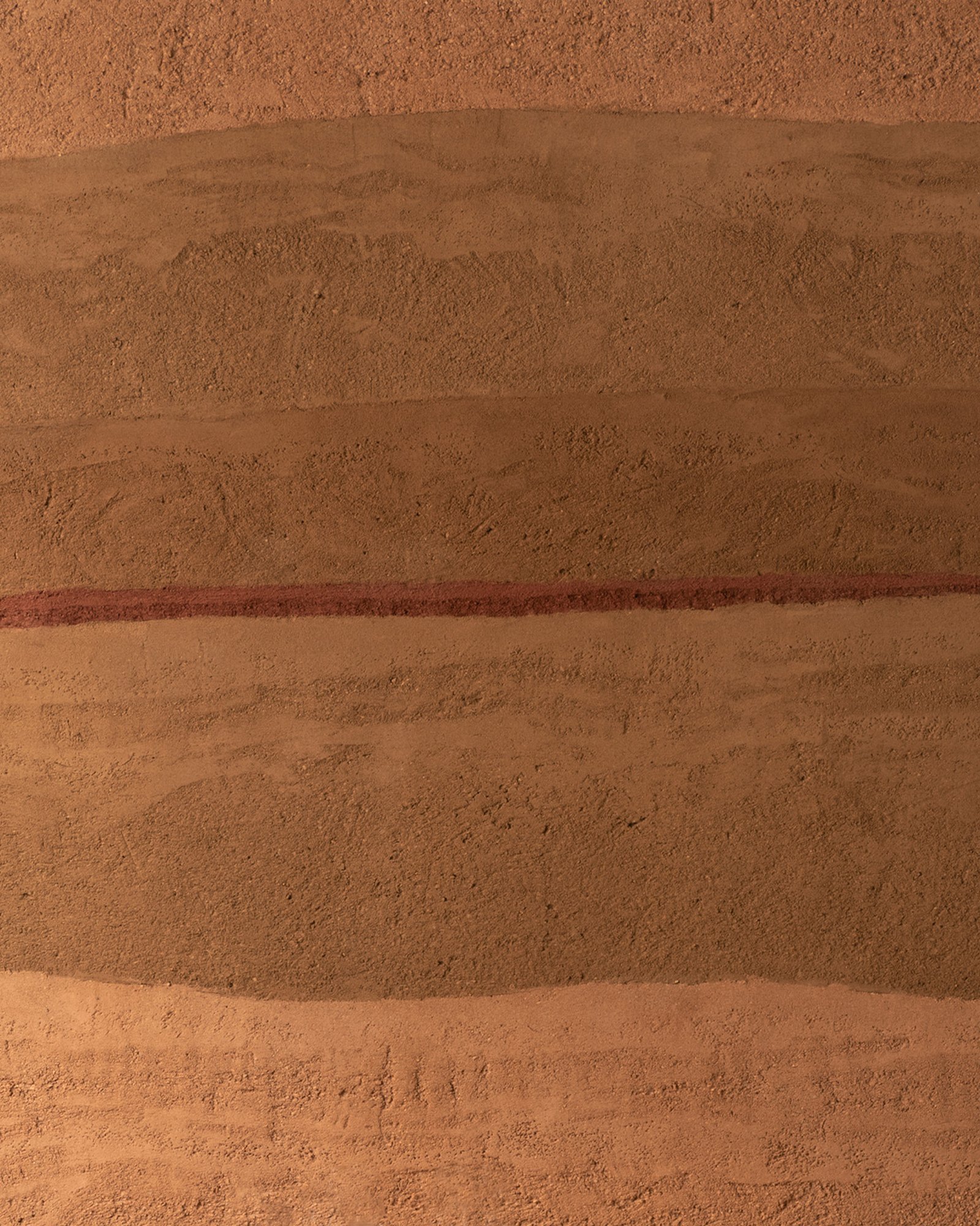 Rammed earth plaster surface detail at Fireplace by Bedrock, Singapore.