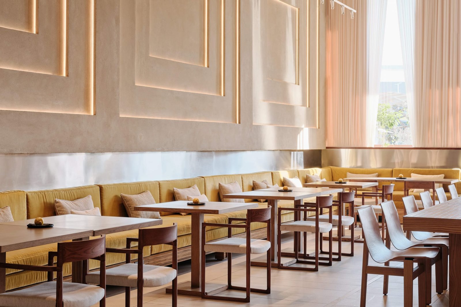 Relief-panelled Demi Rustic clay plaster wall, lit from within, at Toplum, Riyadh