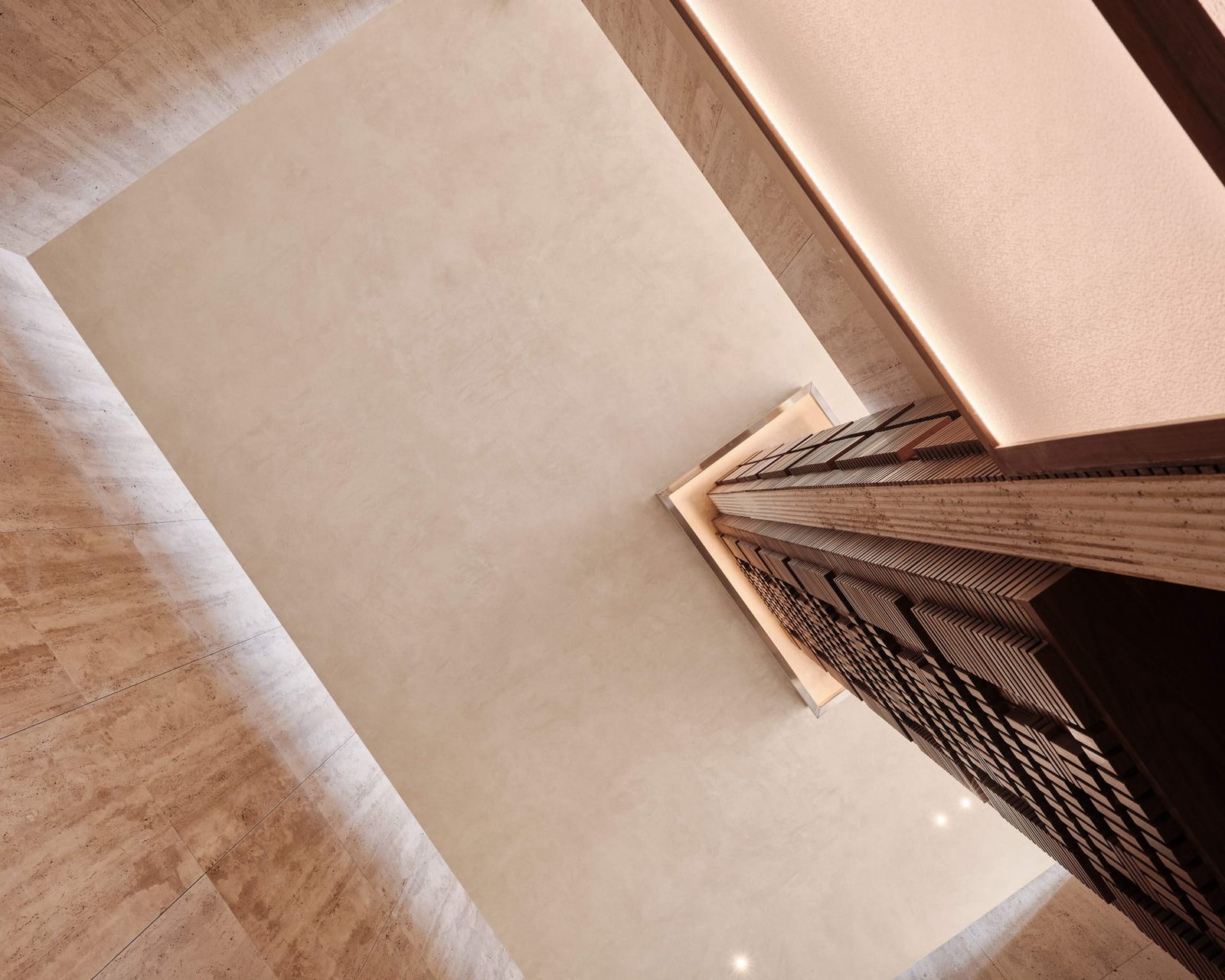 Looking down onto the timber structure and clay plaster wall at Toplum from the mezzanine.