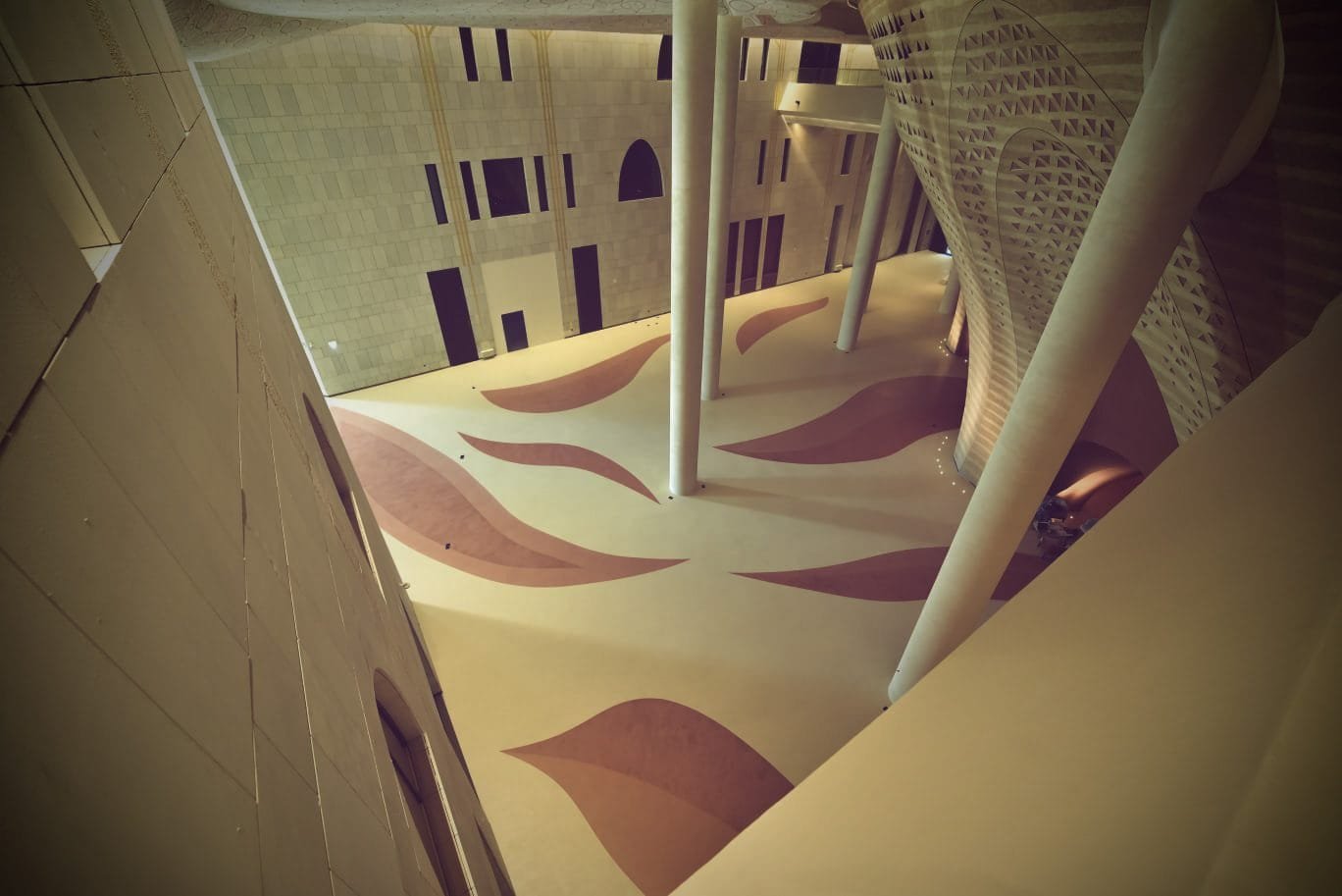 Wide seamless microcement atrium floor with columns at the King Fahad Cultural Centre, Riyadh