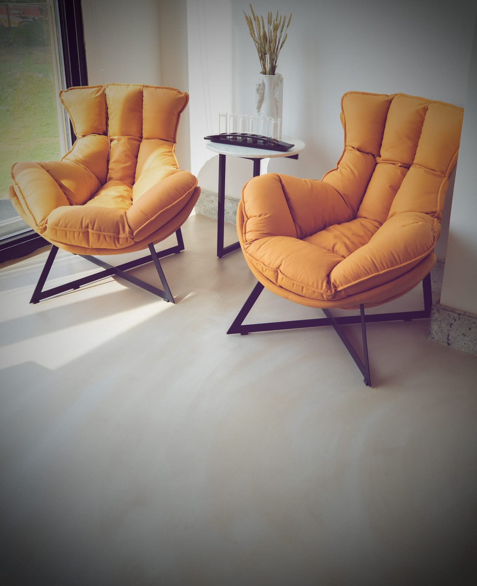 Seamless cream microcement floor beneath lounge seating at Katara Hills, Doha