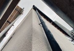 Grey projected cork taken over a roof parapet and down its outer edge